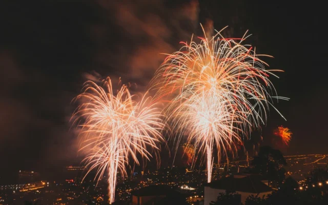 Fireworks bursting over the lights of Funchal on New Year’s Eve, photographed from the hillside district of Livramento