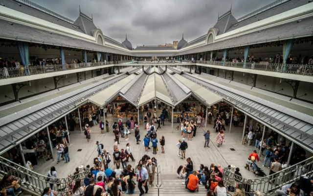Inside Porto’s Mercado do Bolhão, seen from the upper gallery: shoppers in the central courtyard under covered walkways